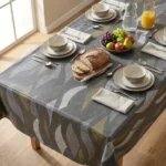 Toile cirée déco Sabine 140 cm – grandes feuilles lancéolées gris argent et or kaki sur fond anthracite texturé, vendue au mètre ou sur mesure
