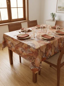 Toile cirée molletonné Mano Terracotta – grand feuillage tropical en tons terracotta et caramel, OEKO-TEX®, largeur 140 cm