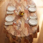Toile cirée molletonné Mano Terracotta – grand feuillage tropical en tons terracotta et caramel, OEKO-TEX®, largeur 140 cm